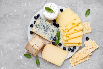 Cheese platter with craft cheese assortment on a marble platter. hard cheeses, mold cheese,...