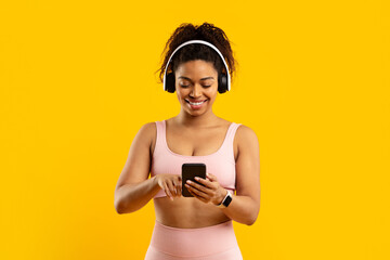 Smiling african american woman with phone and headphones
