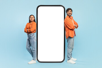Couple with backs turned holding giant smartphone