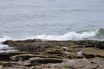 Ocean waves meeting a rocky shore