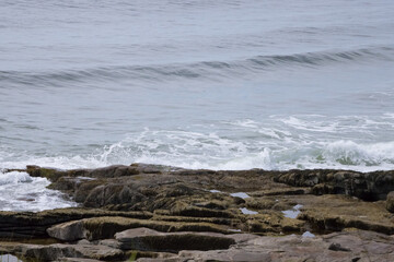 Ocean waves meeting a rocky shore