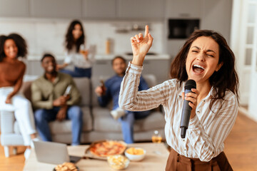 Woman singing with a microphone passionately, have home party