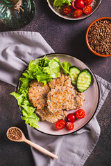 Homemade buckwheat pancakes with fresh vegetables and herbs on a plate top and  vertical view