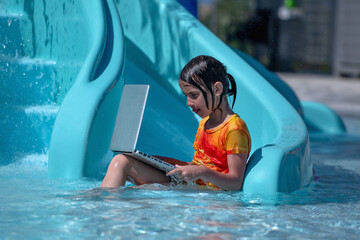 Learning and study everywhere and always concept. Young beautiful girl learning with laptop in the swimming pool. Horiazontal image. Horizontal image. - obrazy, fototapety, plakaty