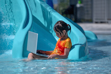 Learning and study everywhere and always. Young beautiful girl learning with laptop in the swimming pool. Horiazontal image.