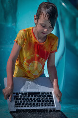 Invalidating and cleaning cache memory concept. Humorous portrait of young girl washes her laptop in the water.