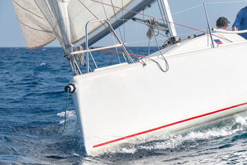 Ocean adventure: white sailing yacht cutting through waves