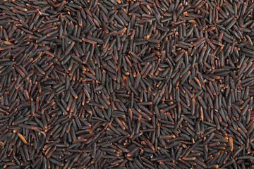 Black rice as a background. Top view. Flat lay