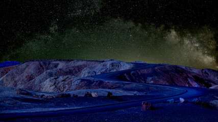 Aced Galaxy milky way surrounded by stars with rock formation on foreground	
 - Powered by Adobe