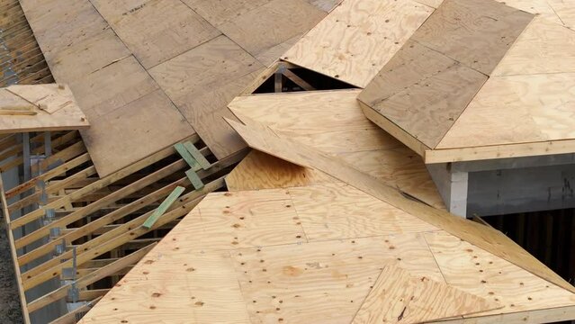 Roofing construction at new house building site. Unfinished plywood rooftop of residential home in Florida suburban area. Housing development concept