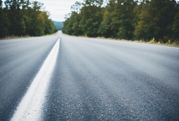 Obraz premium Detailed view of road texture, markings, blurred car in the distance. AI generated.