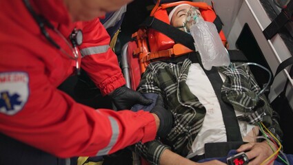 Fototapeta na wymiar Patient, paramedic and blood pressure with oxygen mask in ambulance for emergency, injury or healthcare with neck brace. First responder, person and anesthesia for medical health, support or victim