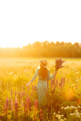 Young woman in lavender field on summer day. Blooming lavender field. Nature, relax, travel and lifestyle.