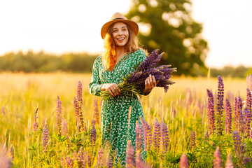 Young woman in lavender field on summer day. Blooming lavender field. Nature, relax, travel and...