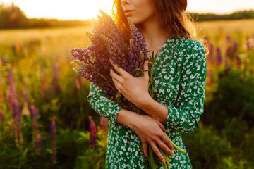 Young woman in lavender field on summer day. Blooming lavender field. Nature, relax, travel and...