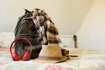 backpack with luggage on a bed