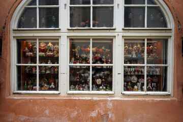 Schönes altes Sprossenfenster in Weiß aus Holz mit Rundbogen als Schaufenster für Souvenirs,...