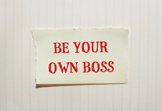 Be your own boss words written on ripped paper with notebook page background. Conceptual be your own boss symbol. Copy space.