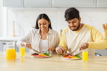 Couple eating healthy meal together happily at kicthen
