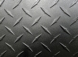 Extreme close-up of brushed dark gradient gray aluminum metal diamond plate design  - 784784489