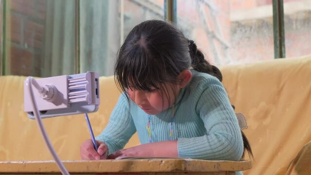 latina child copied cell phone homework at home - education concept