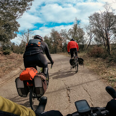 Riding with some bicycle friends with backpack on a road and gravel trip in Girona
