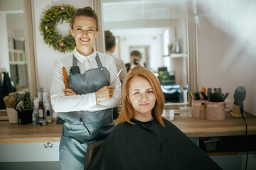 female hairdresser in modern hair studio with scissors - 784788835