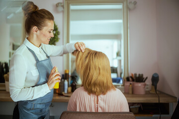 woman hair salon worker in modern beauty studio