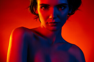 Photo of seductive gorgeous woman naked shoulders smiling teasing isolated red neon color background