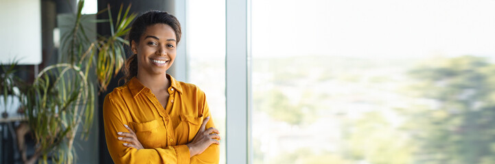 Portrait of confident african american businesswoman standing with folded arms
