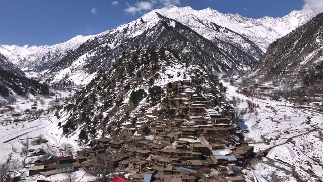 Scenic Kalasha Village in Bamburet Valley in North Pakistan at Winter. Aerial View Hindu Kush Muntain Range Himalayas.