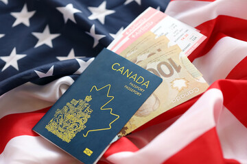 Canadian passport and money on United States national flag background close up. Tourism and diplomacy concept - obrazy, fototapety, plakaty