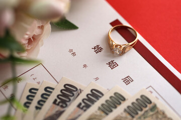 Japanese marriage registration blank document and wedding proposition ring and yen money on table...