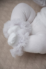 baby feet dressed in white
