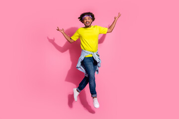Fototapeta na wymiar Photo of nice positive glad man wear stylish yellow clothes good mood jump up isolated on pink color background