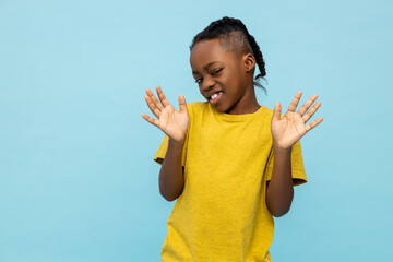 Displeased African American little boy sees something unpleasant
