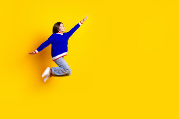 Full length photo of pretty teen girl jumping running fast superhero wear trendy knitwear blue...