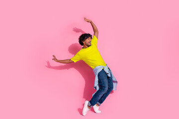 Photo of funky funny man wear trendy yellow clothes look empty space fall down isolated on pink...