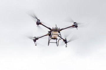 Unmanned aerial vehicle (UAV), commonly known as a drone, for agricultural fertilizer and pesticide spraying