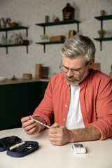 Caucasian diabetic man with insulin syringe injection sitting at table