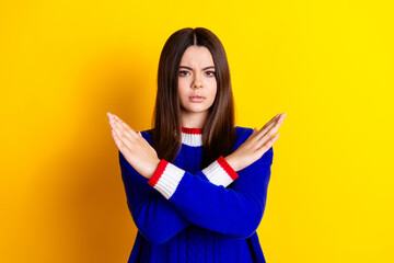 Photo portrait of pretty teen girl crossed hands stop gesture wear trendy knitwear blue outfit isolated on yellow color background