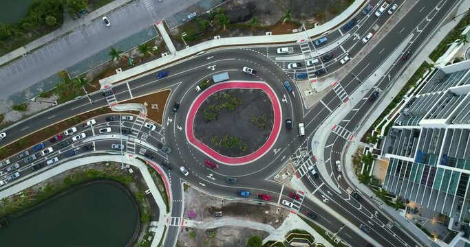 Sarasota, Florida city street traffic on Gulfstream Avenue roundabout intersection with moving cars. Urban circular transportation crossroads.