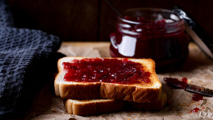Breakfast with toast and jam on a wooden background, selective focus.