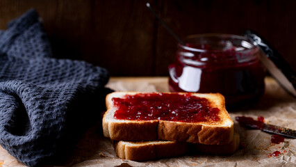 Breakfast with toast and jam on a wooden background, selective focus.