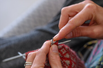 Close up of the hands of an woman knitting sock 2
