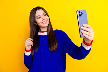 Photo portrait of pretty teen girl selfie photo toothy smile wear trendy knitwear blue outfit isolated on yellow color background
