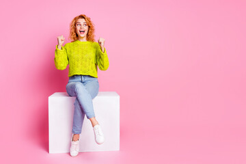 Photo of crazy positive cute woman dressed trendy clothes sitting cube looking empty space isolated...