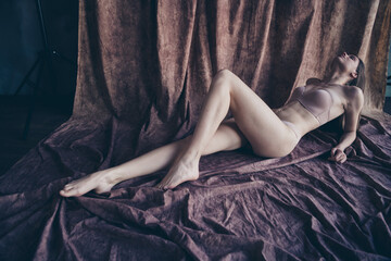 Unretouched photo of gorgeous lady lying floor textile having imaginary sunbathing isolated studio...