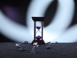 An Hourglass with Vibrant Purple Sand Measuring Time Elegantly