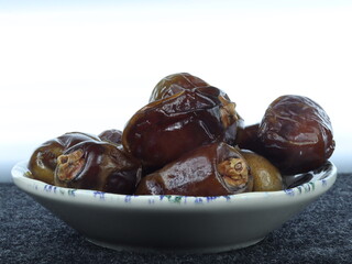 A Small Serving of Dates Arranged Elegantly on a Plate